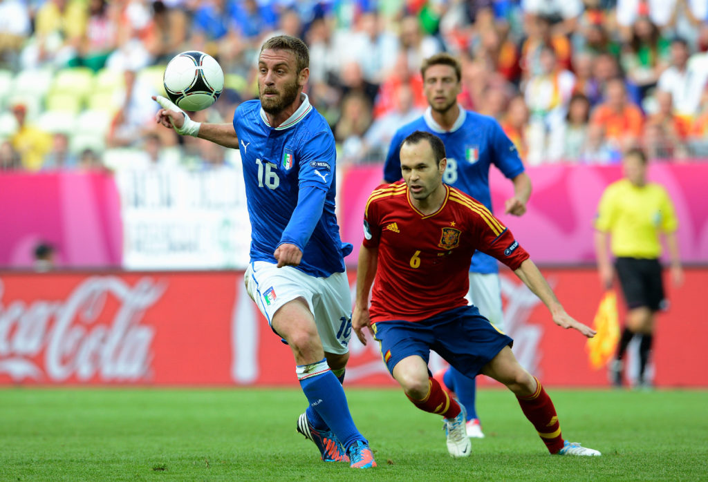 GDANSK, POLAND - JUNE 10: Daniele De Rossi of Italy and Andres Iniesta of Spain compete for the ball during the UEFA EURO 2012 group C match between Spain and Italy at The Municipal Stadium on June 10, 2012 in Gdansk, Poland. (Photo by Claudio Villa/Getty Images)